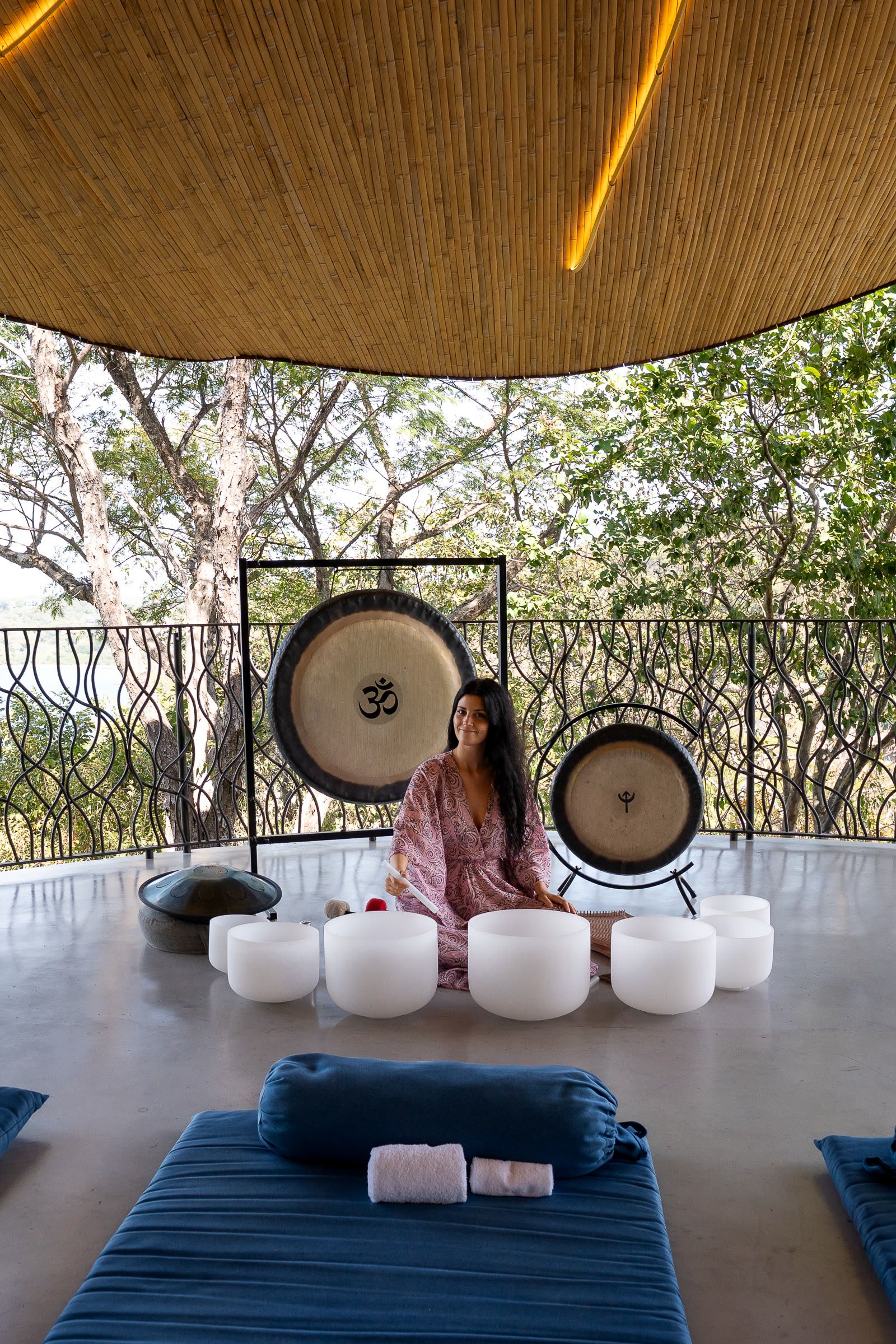 Harriet Emily with gongs and crystal bowls in an open-air pavilion at Four Seasons, Costa Rica